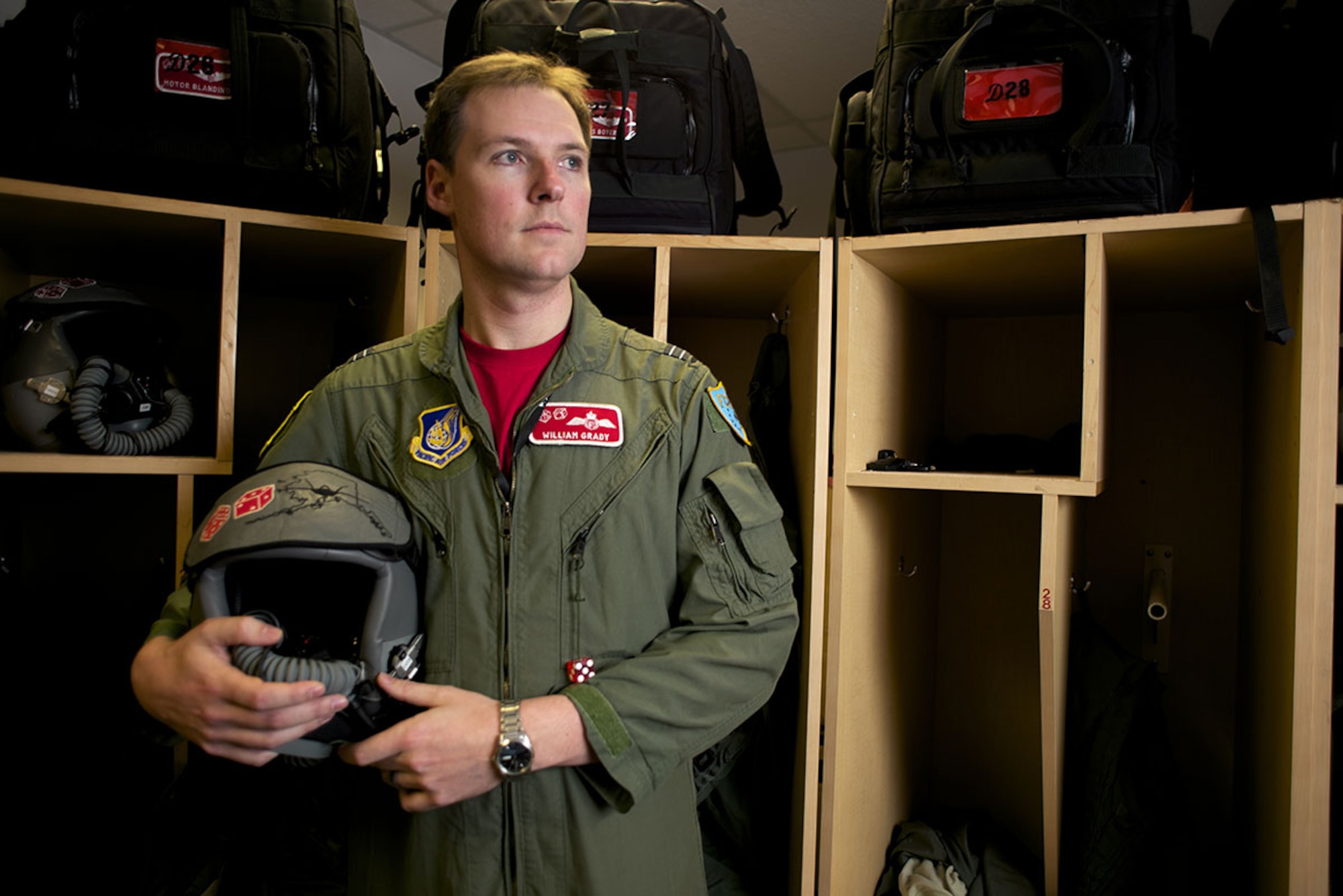 Royal Australian Air Force exchange pilot Flight Lt. William Grady, callsign "Gradz," stands in the 90th Fighter Squadron hangar on Joint Base Elmendorf-Richardson. Australians have continuously assigned exchange pilots to the 90th FS for more than 70 years. (U.S. Air Force photo/David Bedard)