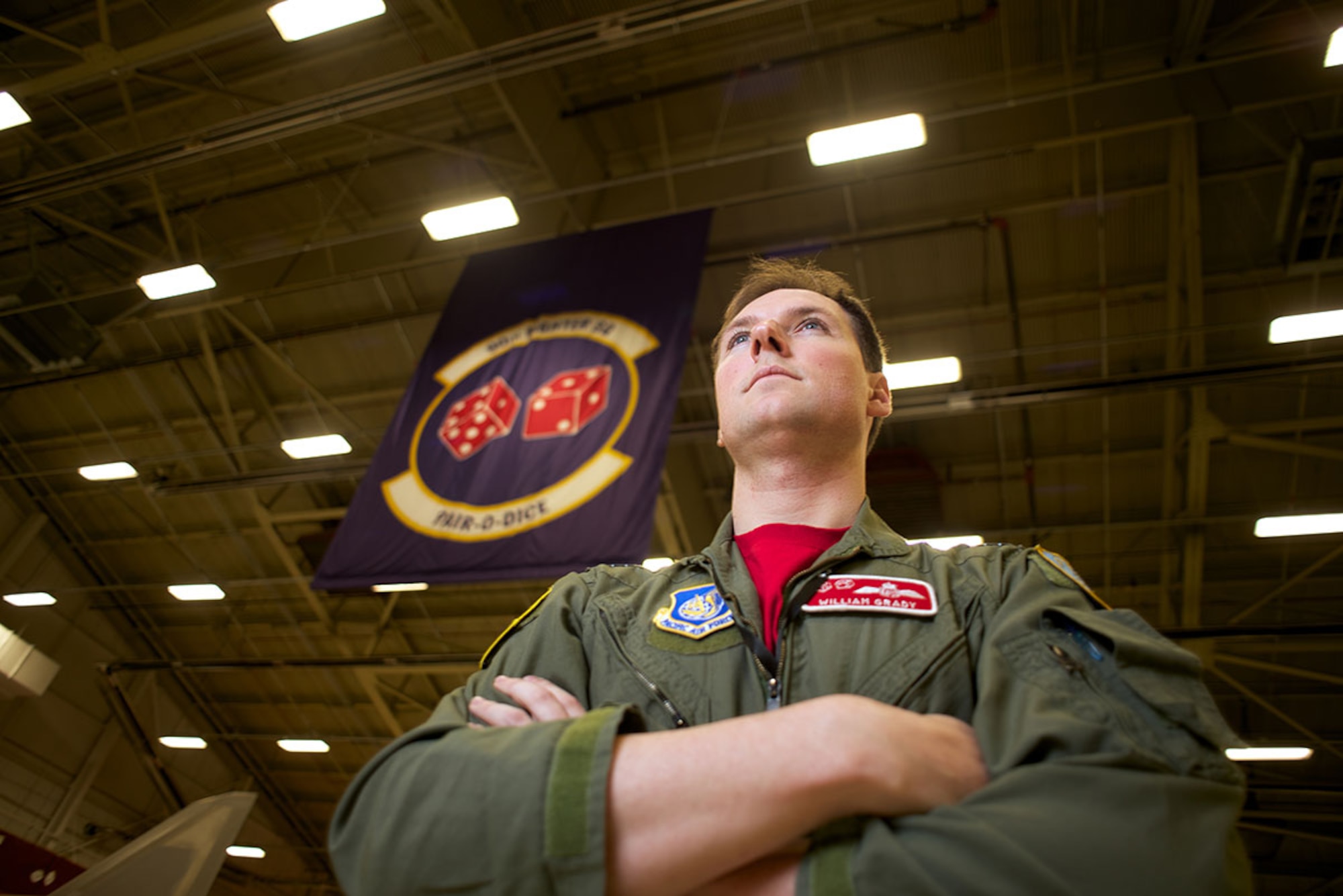 Royal Australian Air Force exchange pilot Flight Lt. William Grady, callsign “Gradz,” stands in the 90th Fighter Squadron hangar on Joint Base Elmendorf-Richardson. Australians have continuously assigned exchange pilots to the 90th FS for more than 70 years. (U.S. Air Force photo/David Bedard)