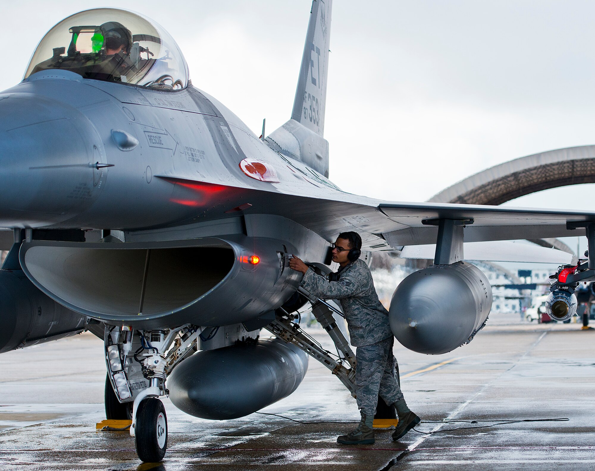 Senior Airman Roderick Ponton, a 96th Aircraft Maintenance Squadron crew chief, closes a panel on an F-16 Fighting Falcon prior to a morning sortie at Eglin Air Force Base, Fla.  The 96th AMXS is responsible for the maintenance of all the test aircraft for the 96th Test Wing and the 85th Test and Evaluation Squadron.  (U.S. Air Force photo/Samuel King Jr.)