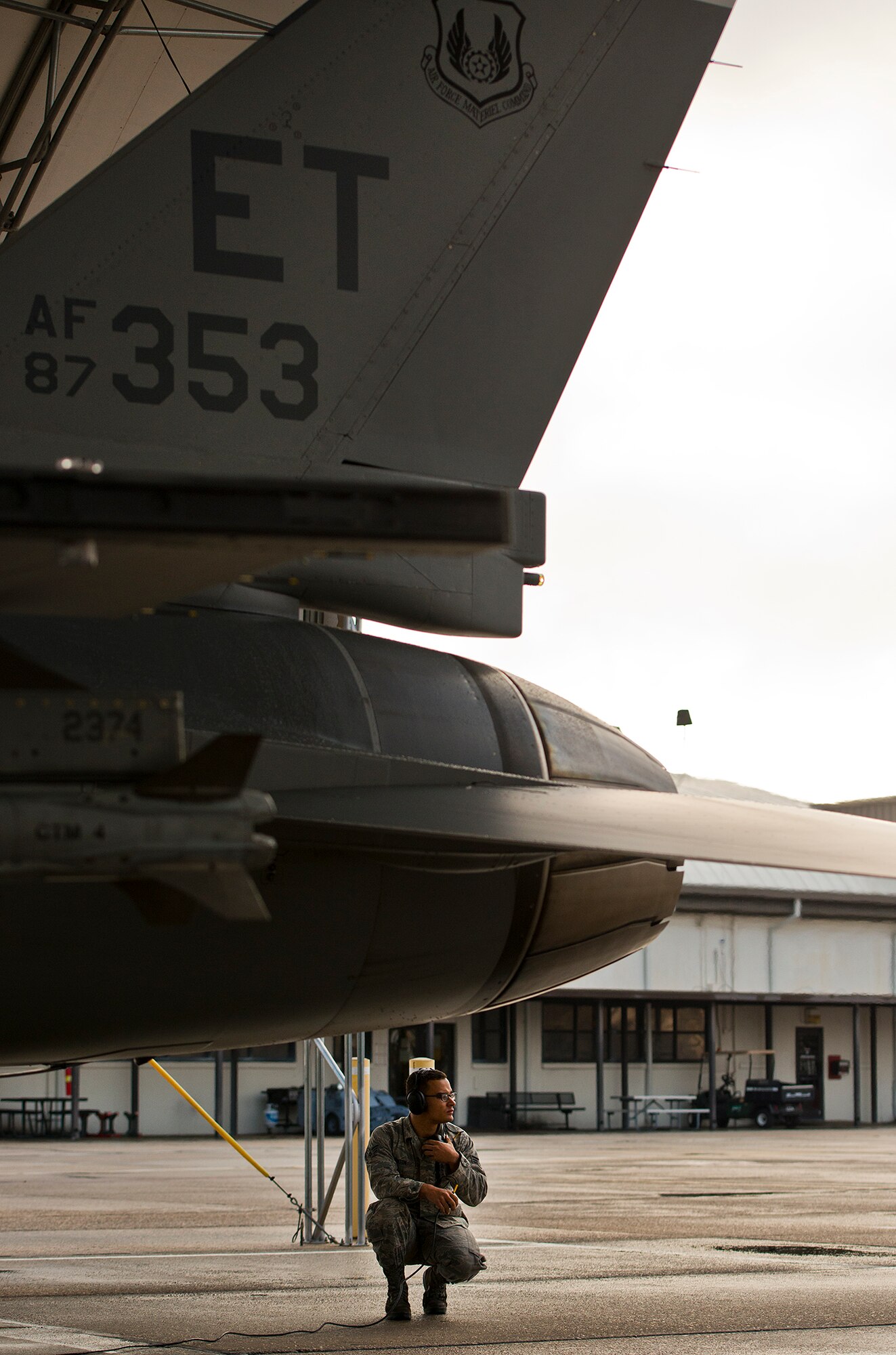 Senior Airman Roderick Ponton, a 96th Aircraft Maintenance Squadron crew chief, looks out over the flightline during preflight checks on an F-16 Fighting Falcon prior to a morning sortie at Eglin Air Force Base, Fla.  The 96th AMXS is responsible for the maintenance of all the test aircraft for the 96th Test Wing and the 85th Test and Evaluation Squadron.  (U.S. Air Force photo/Samuel King Jr.)