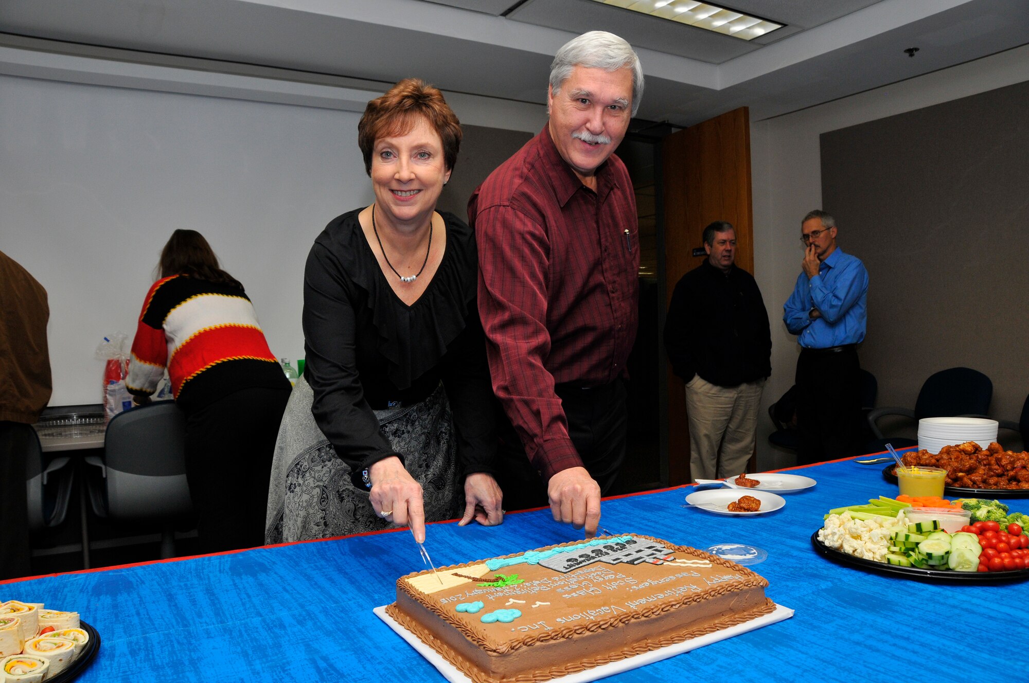 A retirement party was held for Aerospace Testing Alliance (ATA) employees Peggy and Scott Glass, allowing coworkers and friends to congratulate the couple and say their farewells. Peggy served as the business manager for investment projects and worked at Arnold Engineering Development Complex (AEDC) almost 22 years. Scott served ATA as an enterprise IT system architect. He worked at the base for 29 years. They are from Tullahoma. Peggy and Scott are pictured here cutting the cake at their retirement celebration. (Photo by Rick Goodfriend)