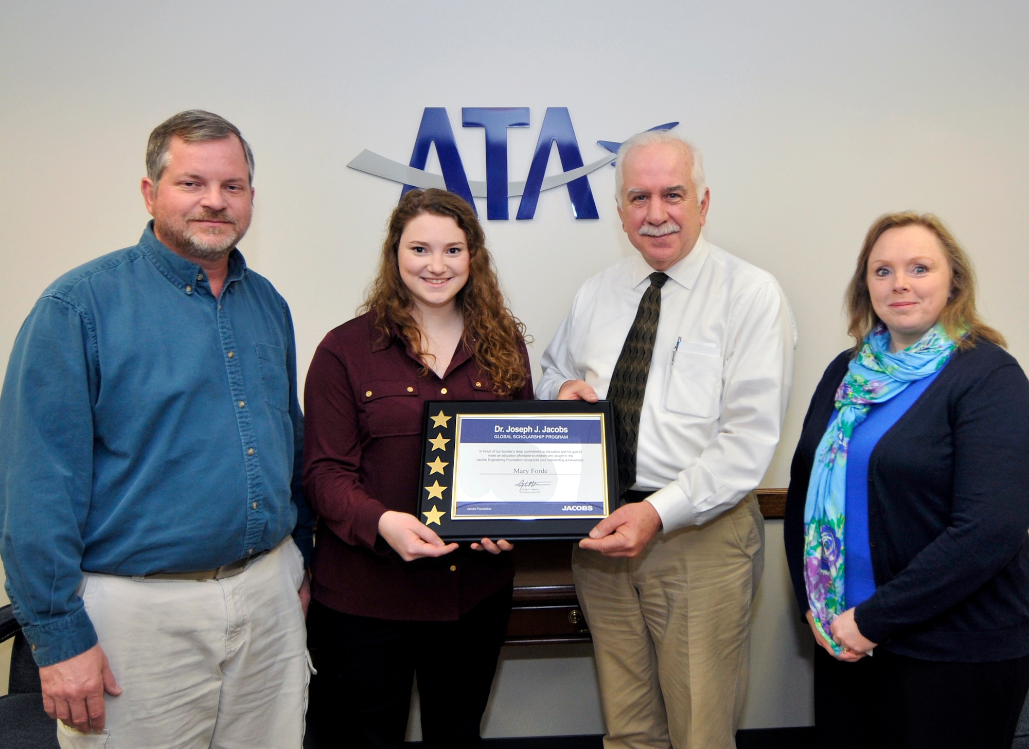Mary Forde (second from left), a recipient of the Dr. Joseph J. Jacobs Global Scholarship, accepts her award from ATA General Manager Steve Pearson (second from right). Pictured with Mary are her parents Bob (far left) and Janet Forde. (Photo by Jacqueline Cowan)