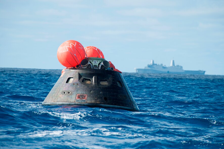 NASA's Orion spacecraft awaits the U.S. Navy's USS Anchorage for a ride home. Orion launched into space on a two-orbit, 4.5-hour test flight at 7:05 am EST on Dec. 5, and safely splashed down in the Pacific Ocean, where a combined team from NASA, the Navy and Orion prime contractor Lockheed Martin retrieved it for return to shore on board the Anchorage. (U.S. Navy Photo) 