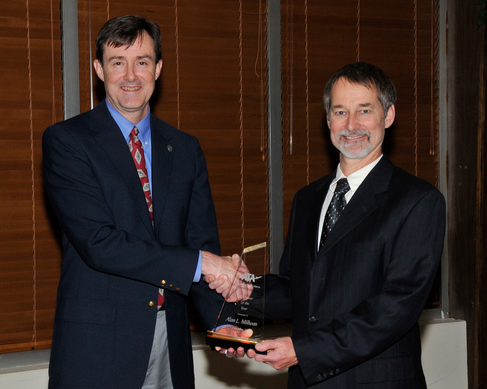 Al Milhoan, ATA control system architect, was chosen as the recipient of the ATA Engineer of the Year Award for 2014. Milhoan was selected for this honor to recognize his contributions and dedication to his work at AEDC. Pictured is ATA director of Test and Evaluation Dr. Rob McAmis presenting Milhoan, right, with the award at the ATA Awards Banquet. (Photo by Rick Goodfriend)