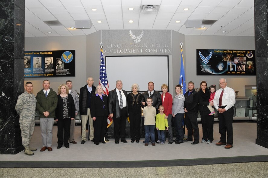 The family of John Sipe recently visited the base to view the Arnold Engineering Development Complex (AEDC) Memorial, located outside of the A&E building in honor of those who were serving out the Complex’s mission. When an explosion occurred in a test cell on Nov. 27, 1982, John Sipe was one of the crew members killed in the incident and his name is listed on the memorial. Jennifer Sipe, the daughter-in-law of Faye Mays of Manchester, John’s widow, made arrangements for the family to visit the Memorial, since she and several others in the family had never viewed it. Col. Raymond Toth, AEDC commander, and Steve Pearson, Aerospace Testing Alliance (ATA) general manager, met and spoke to the family during their visit. Pictured left to right: Col. Raymond Toth; Paul Sipe, son; Jennifer Sipe, daughter-in-law; Jonathan Sipe, son; Lonnie and Debbie Lance, brother-in-law and sister-in-law; Sherman Mays, husband of Faye Sipe Mays; Faye Mays, widow; Bill Sipe, son; Tina Sipe, daughter-in-law; Nikki Sipe Anderson, granddaughter; Steven Sipe, grandson; Cara Gray holding Hannah Anderson, great-granddaughter; and ATA General Manager Steve Pearson. In front are Jacob and Lily Anderson, great-grandchildren. (Photo by Rick Goodfriend)