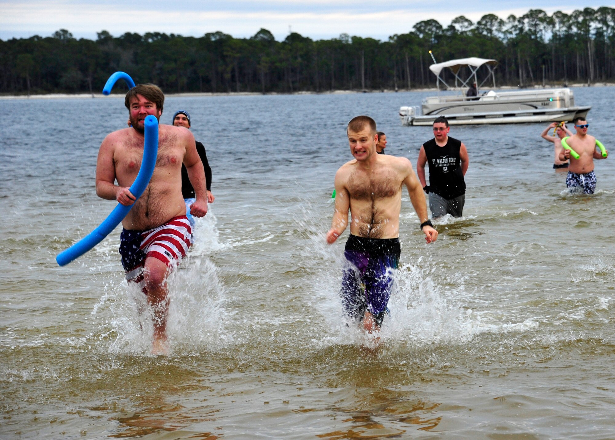 Participants endure a brisk run in the waters of Weekly Bayou during Eglin’s annual Polar Bear Plunge at Post’l Point, Jan. 9.  Approximately 50 people braved frigid morning temperatures to rush into the 57 degree water.  According to local weather reports, it was 32 degrees with a 27 degree wind chill factor. (U.S. Air Force photo/Ilka Cole)