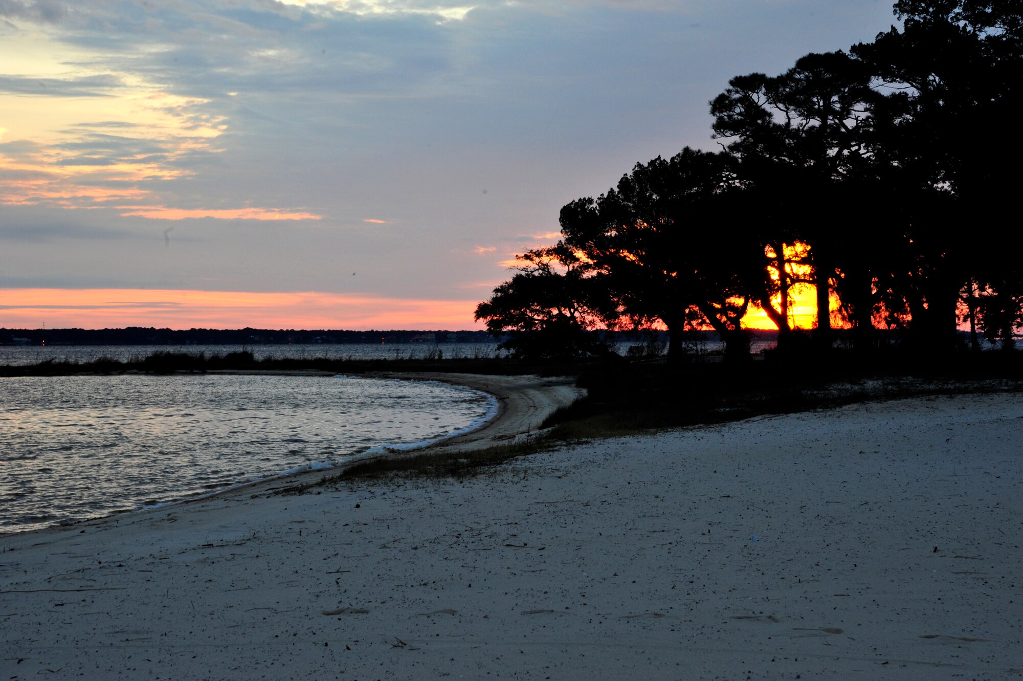 The sun peaks through the tree line at Post’l Point before the start of Eglin’s annual Polar Bear Plunge, Jan. 9. Approximately 50 people braved frigid morning temperatures to rush into the 57 degree water. According to local weather reports, it was 32 degrees with a 27 degree wind chill factor. (U.S. Air Force photo/Ilka Cole)