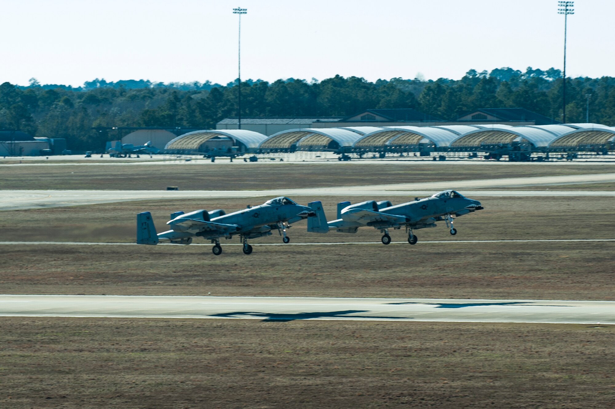 Two A-10C Thunderbolt IIs take off toward the skies of Valdosta, Ga., Jan. 8, 2015, at Moody Air Force Base, Ga. Moody’s air traffic control team tracks all Moody aircraft to provide a safe flow of aircraft on the flightline and in the air.  (U.S. Air Force photo by Airman 1st Class Dillian Bamman/Released)
