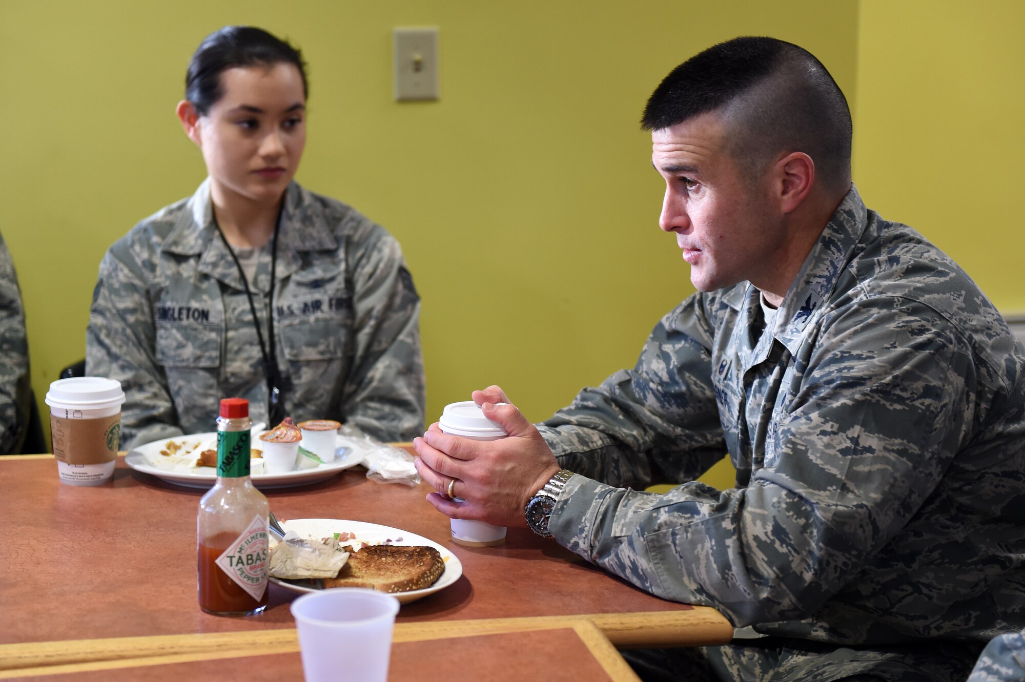 Col. John Wagner, 460th Space Wing commander, right, speaks with Airmen during a breakfast with leadership Jan. 9, 2015, at the Panther Den on Buckley Air Force Base, Colo. During the breakfast, leadership sought out Airmen’s thoughts and opinions on what they could do to make Buckley the best base in the Air Force. (U.S. Air Force photo by Airman 1st Class Emily E. Amyotte/Released)
