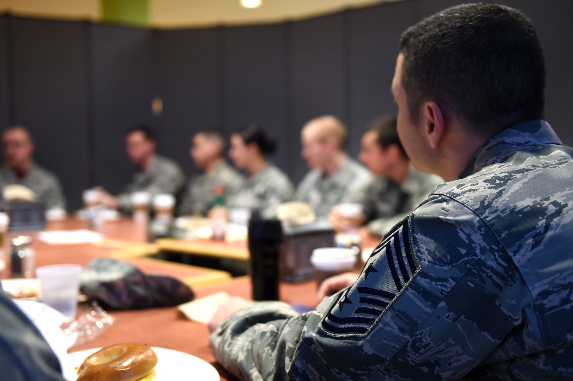 Chief Master Sgt. Brian Kruzelnick, 460th Space Wing command chief, center, listens to Airmen during a breakfast with Airmen and the 460th SW commander, Col. John Wagner, Jan. 9, 2015, at the Panther Den on Buckley Air Force Base, Colo. During the breakfast, leadership sought out Airmen’s thoughts and opinions on what they could do to make Buckley the best base in the Air Force. (U.S. Air Force photo by Airman 1st Class Emily E. Amyotte/Released)