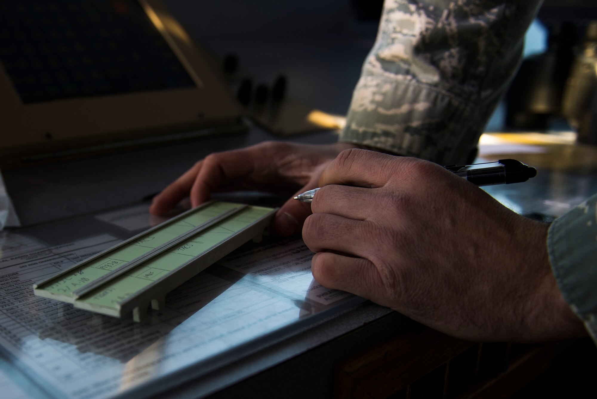 U.S. Air Force Senior Airman Joshua Dermody, 23d Operations Support Squadron air traffic control journeyman, writes aircraft specifications on a flight progress strip Jan. 8, 2015, at Moody Air Force Base, Ga. ATC Airmen use these strips to track all  Moody in-flight aircraft to ensure safe departures, flights and landings. (U.S. Air Force photo by Airman 1st Class Dillian Bamman/Released)
