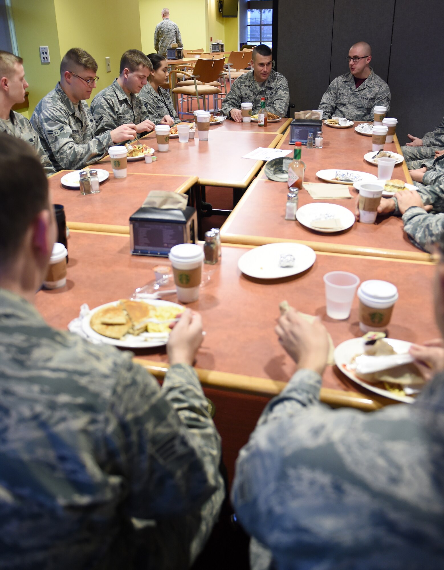 Airmen sit and speak with the base commander and command chief during a breakfast with leadership Jan. 9, 2015, at the Panther Den on Buckley Air Force Base, Colo. During the breakfast, leadership sought out Airmen’s thoughts and opinions on what they could do to make Buckley the best base in the Air Force. (U.S. Air Force photo by Airman 1st Class Emily E. Amyotte/Released)