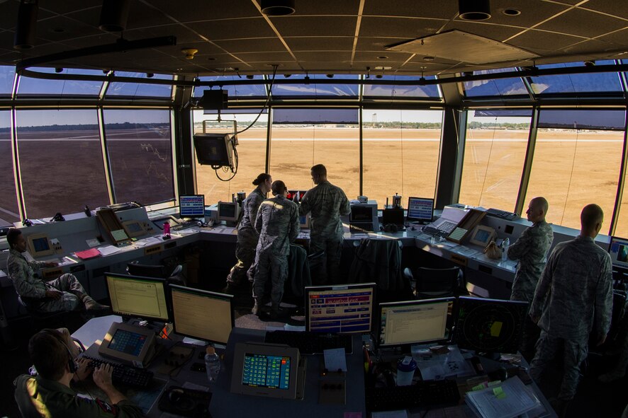 Airmen from the 23d Operations Support Squadron monitor the skies for aircraft and weather conditions from inside the control tower Dec. 10, 2014, at Moody Air Force Base, Ga. Air traffic control tower Airmen manage the flow of all air traffic on the flightline and within a 5-mile radius of Moody. (U.S. Air Force photo by Airman 1st Class Dillian Bamman/Released)
