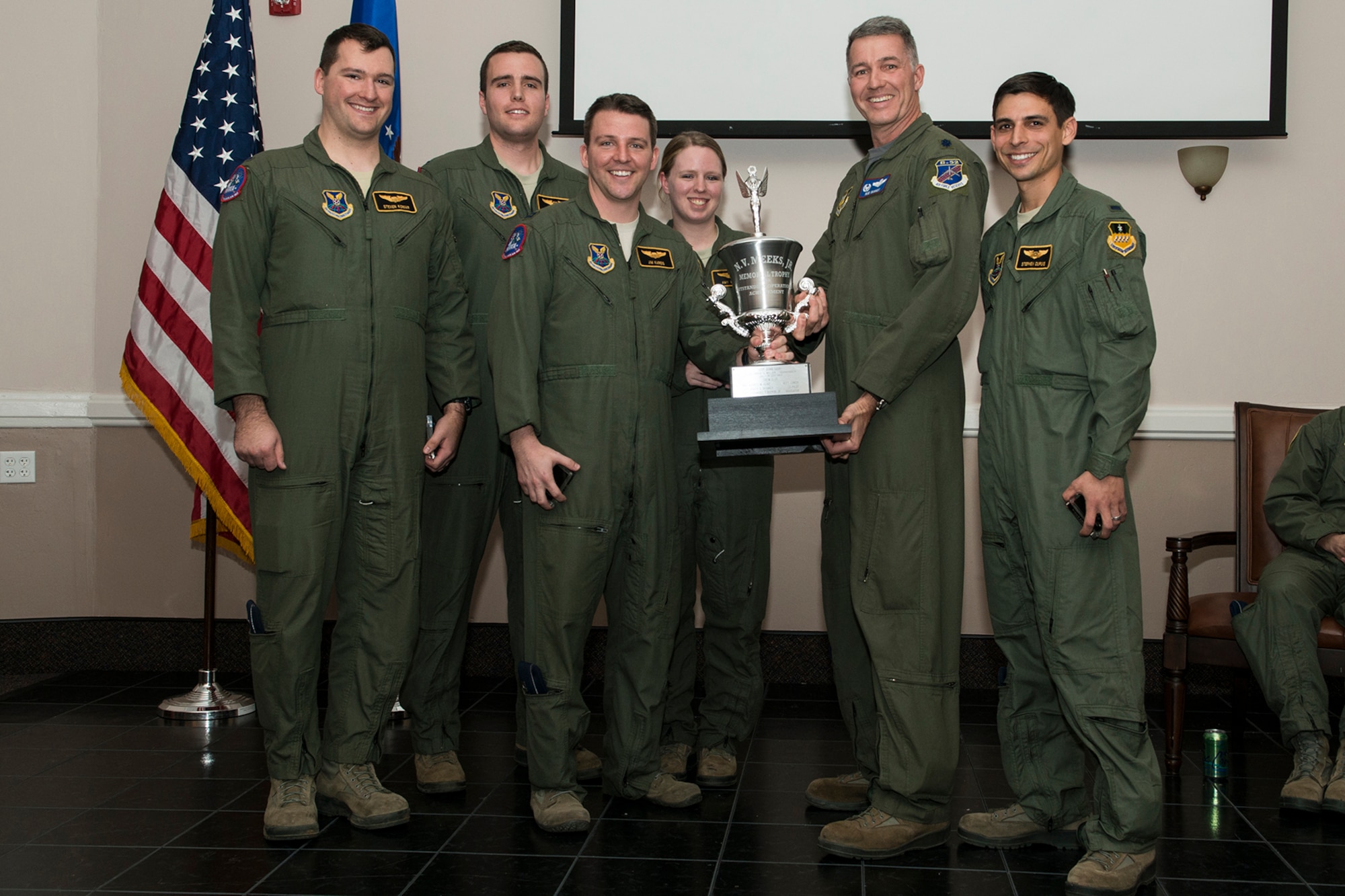 U.S. Air Force Lt. Col. Robert Van Hoy, 93rd Bomb Squadron commander, presents the Meeks Outstanding Crew Award to crew TUFF 23 during a Formal Training Unit graduation ceremony, Jan. 9, 2015, Barksdale Air Force Base, La. The award is presented to the student aircrew that performs the best throughout the flight line phase of training, and the crew members are Capt. James Kareis, Aircraft Commander, 1st Lt. Steven Koniar, Copilot, 1st Lt. Bryant Curdy, Dual Seat Navigator, 1st Lt. Amy Watson, Dual Seat Navigator and 1st Lt. Stephen Dupuis, Electronic Warfare Officer. (U.S. Air Force photo by Master Sgt. Greg Steele/Released)