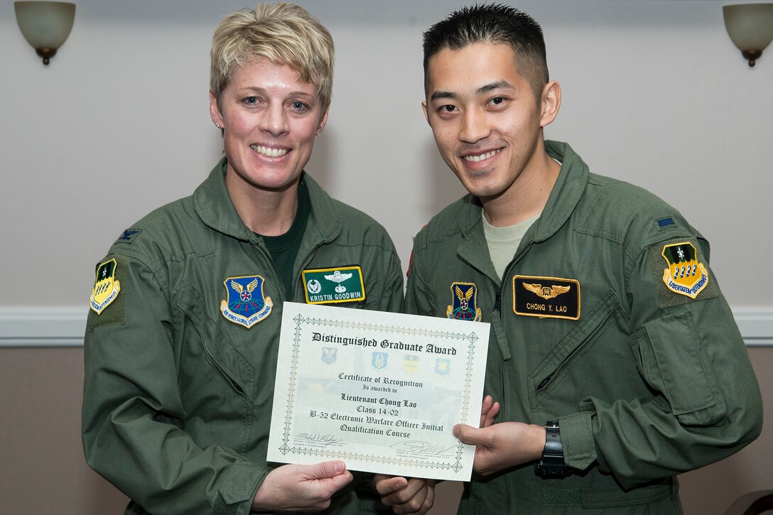 U.S. Air Force Col. Kristin Goodwin, 2nd Bomb Wing commander, presents the Distinguished Graduate Award to 1st Lt. Chong Lao during a Formal Training Unit (FTU) graduation ceremony, Jan. 9, 2015, Barksdale Air Force Base, La. Lao graduated from the FTU as a electronic weapons officer on the B-52H Stratofortress. (U.S. Air Force photo by Master Sgt. Greg Steele/Released)