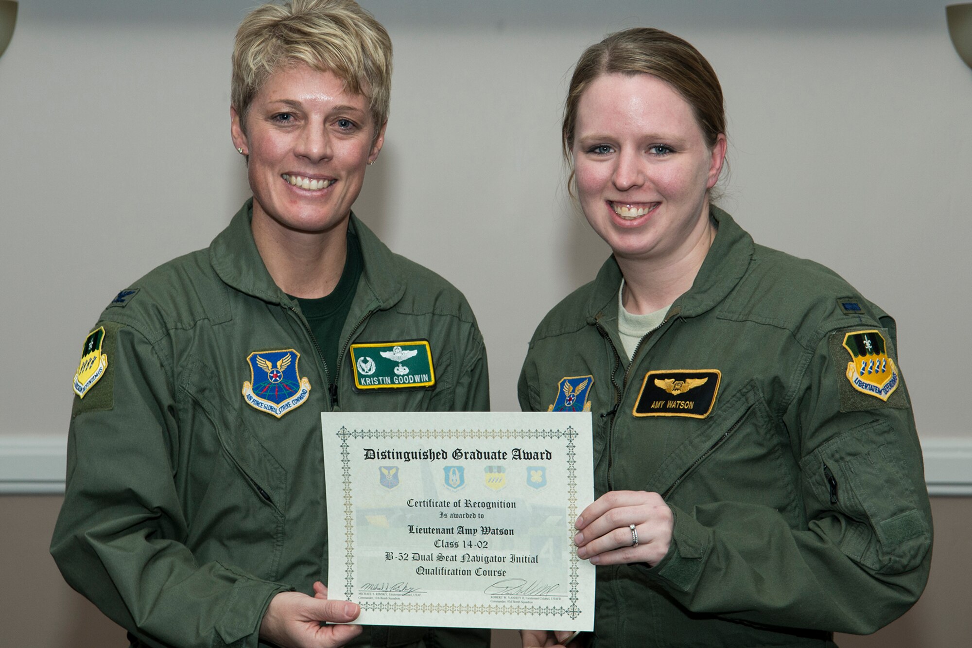 U.S. Air Force Col. Kristin Goodwin, 2nd Bomb Wing commander, presents the Distinguished Graduate Award to 1st Lt. Amy Watson during a Formal Training Unit (FTU) graduation ceremony, Jan. 9, 2015, Barksdale Air Force Base, La. Watson graduated from the FTU as a navigator on the B-52H Stratofortress. (U.S. Air Force photo by Master Sgt. Greg Steele/Released)