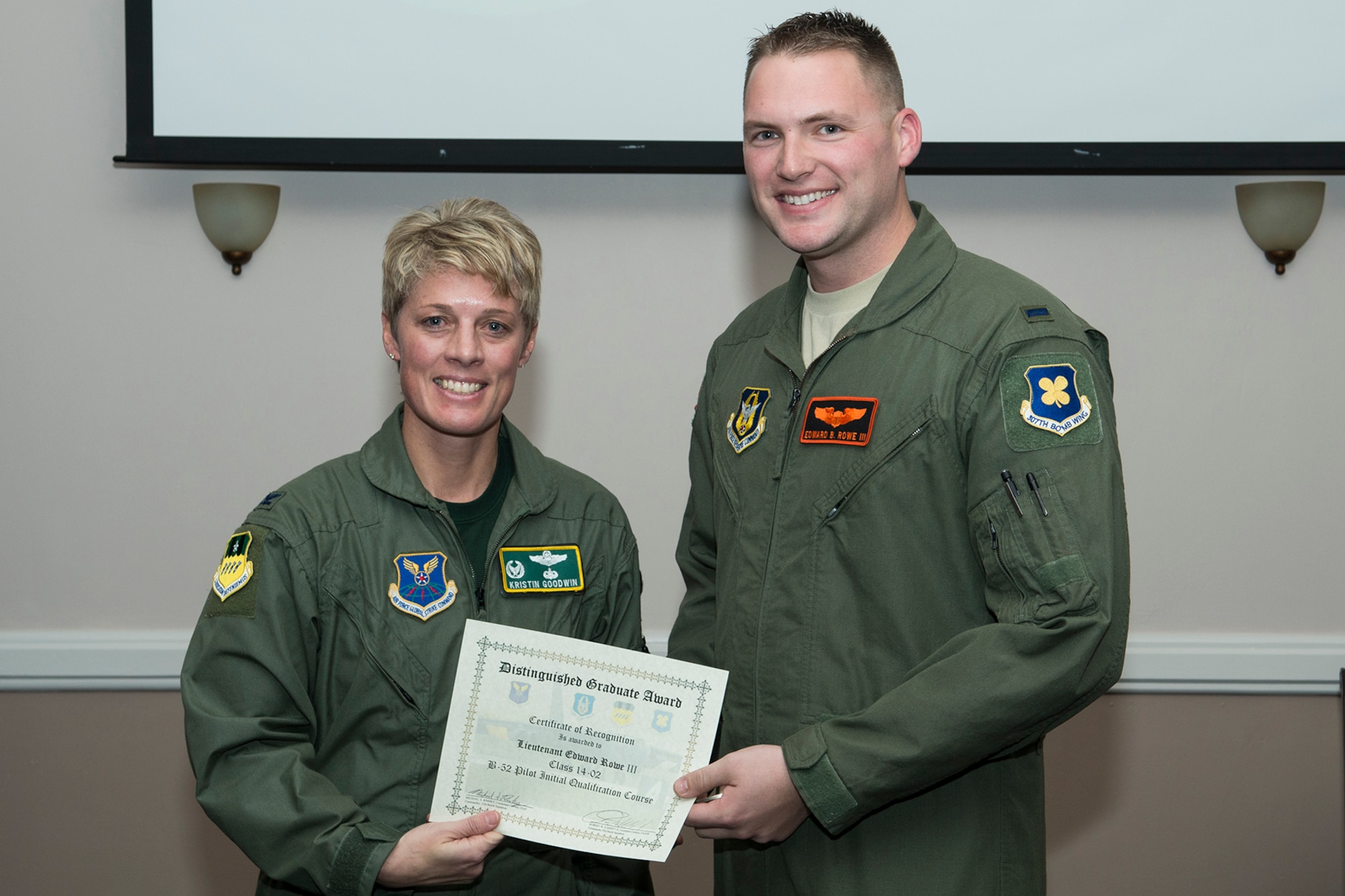 U.S. Air Force Col. Kristin Goodwin, 2nd Bomb Wing commander, presents the Distinguished Graduate Award to 1st Lt. Edward Rowe III during a Formal Training Unit (FTU) graduation ceremony, Jan. 9, 2015, Barksdale Air Force Base, La. Rowe graduated from the FTU as a pilot on the B-52H Stratofortress. (U.S. Air Force photo by Master Sgt. Greg Steele/Released)