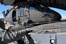 Lt. Col. Ronnie Schier, aircraft commander, and Master Sgt. Eric Walker, loadmaster, bother from the 701st Airlift Squadron pose for a quick photo with a UH-60 Black Hawk  helicopter inside a Joint Base Charleston C-17 during a joint airlift training mission with members of the South Carolina Army National Guard this past weekend. U.S. Soldiers from Company A, 1-111th Aviation Battalion, South Carolina Army National Guard, loaded the Black Hawk onto the C-17  during drill weekend at McEntire Joint National Guard Base, Eastover, South Carolina, January 10, 2015. The joint training exercise allows both units to gain knowledge, practice, and experience loading a UH-60 Black Hawk, and provides an opportunity for the South Carolina Army National Guard to meet the Army’s Future Force projection of a knowledge-based component of a joint, interagency, intergovernmental, multi national (JIIM) force. (US Army National Guard Photo by Staff Sgt. Di Giovine)