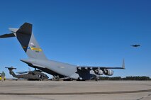 U.S. Soldiers from Company A, 1-111th Aviation Battalion, South Carolina Army National Guard, load a UH-60 Black Hawk onto a C-17 Globemaster III from the 701st Airlift Squadron, 315th Airlift Wing, Joint Base Charleston, during drill weekend at McEntire Joint National Guard Base, Eastover, S.C., Jan. 10, 2015. The joint training exercise allows both units to gain knowledge, practice, and experience loading a UH-60 Black Hawk, and provides an opportunity for the South Carolina Army National Guard to meet the Army’s Future Force projection of a knowledge-based component of a joint, interagency, intergovernmental, multinational (JIIM) force. (U.S. Army National Guard Photo by Staff Sgt. Di Giovine)