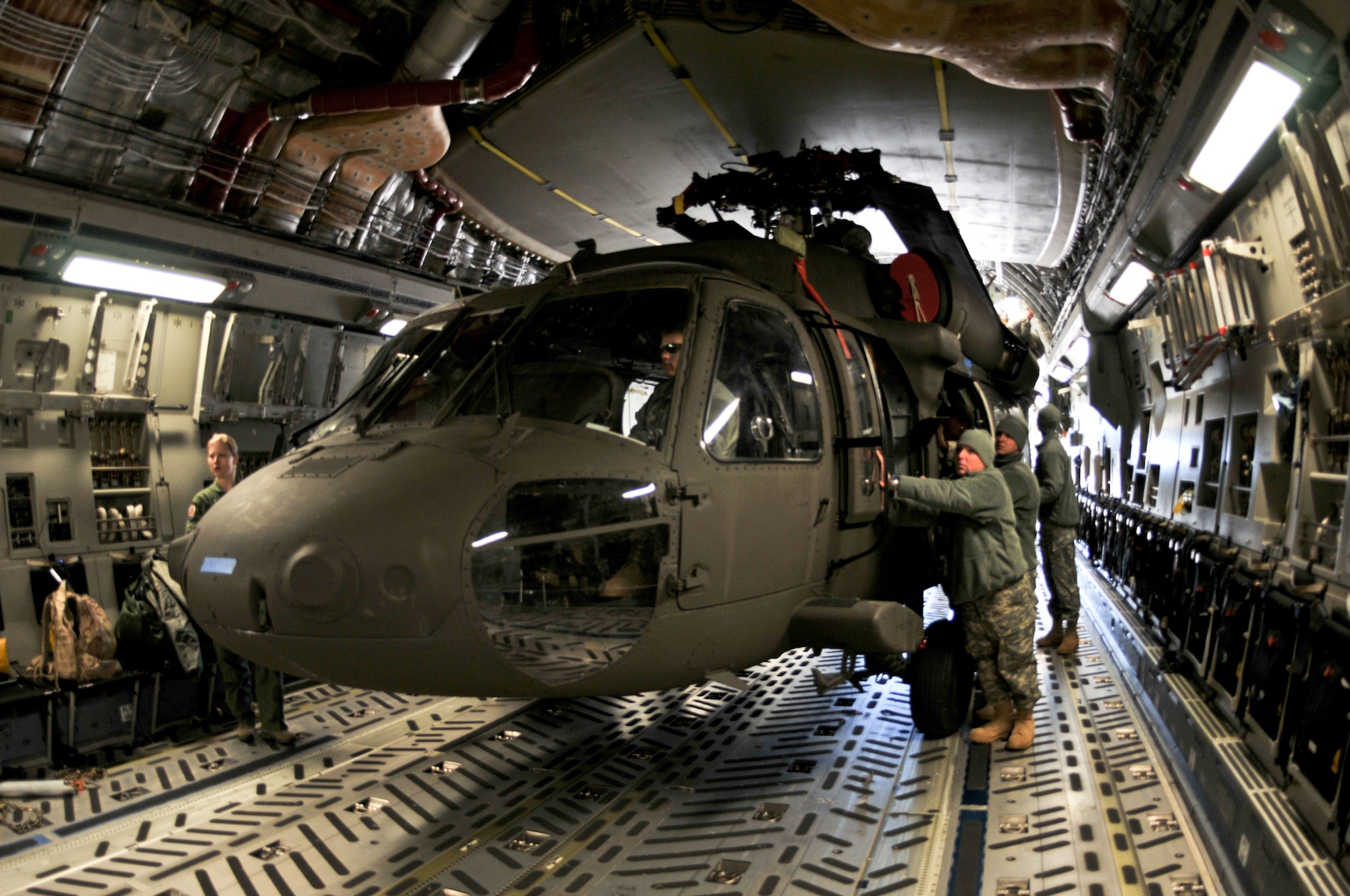 U.S. Soldiers from Company A, 1-111th Aviation Battalion, South Carolina Army National Guard, load a UH-60 Black Hawk onto a C-17 Globemaster III from the 701th Airlift Squadron, 315th Airlift Wing, Joint Base Charleston, during drill weekend at McEntire Joint National Guard Base, Eastover, S.C., Jan. 10, 2015. The joint training exercise allows both units to gain knowledge, practice, and experience loading a UH-60 Black Hawk, and provides an opportunity for the South Carolina Army National Guard to meet the Army’s Future Force projection of a knowledge-based component of a joint, interagency, intergovernmental, multinational (JIIM) force. (U.S. Army National Guard Photo by Staff Sgt. Di Giovine)
