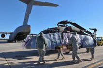 U.S. Soldiers from Company A, 1-111th Aviation Battalion, South Carolina Army National Guard, load a UH-60 Black Hawk onto a C-17 Globemaster III from the 701st Airlift Squadron, 315th Airlift Wing, Joint Base Charleston, during drill weekend at McEntire Joint National Guard Base, Eastover, S.C., Jan. 10, 2015. The joint training exercise allows both units to gain knowledge, practice, and experience loading a UH-60 Black Hawk, and provides an opportunity for the South Carolina Army National Guard to meet the Army’s Future Force projection of a knowledge-based component of a joint, interagency, intergovernmental, multinational (JIIM) force. (U.S. Army National Guard Photo by Staff Sgt. Di Giovine)
