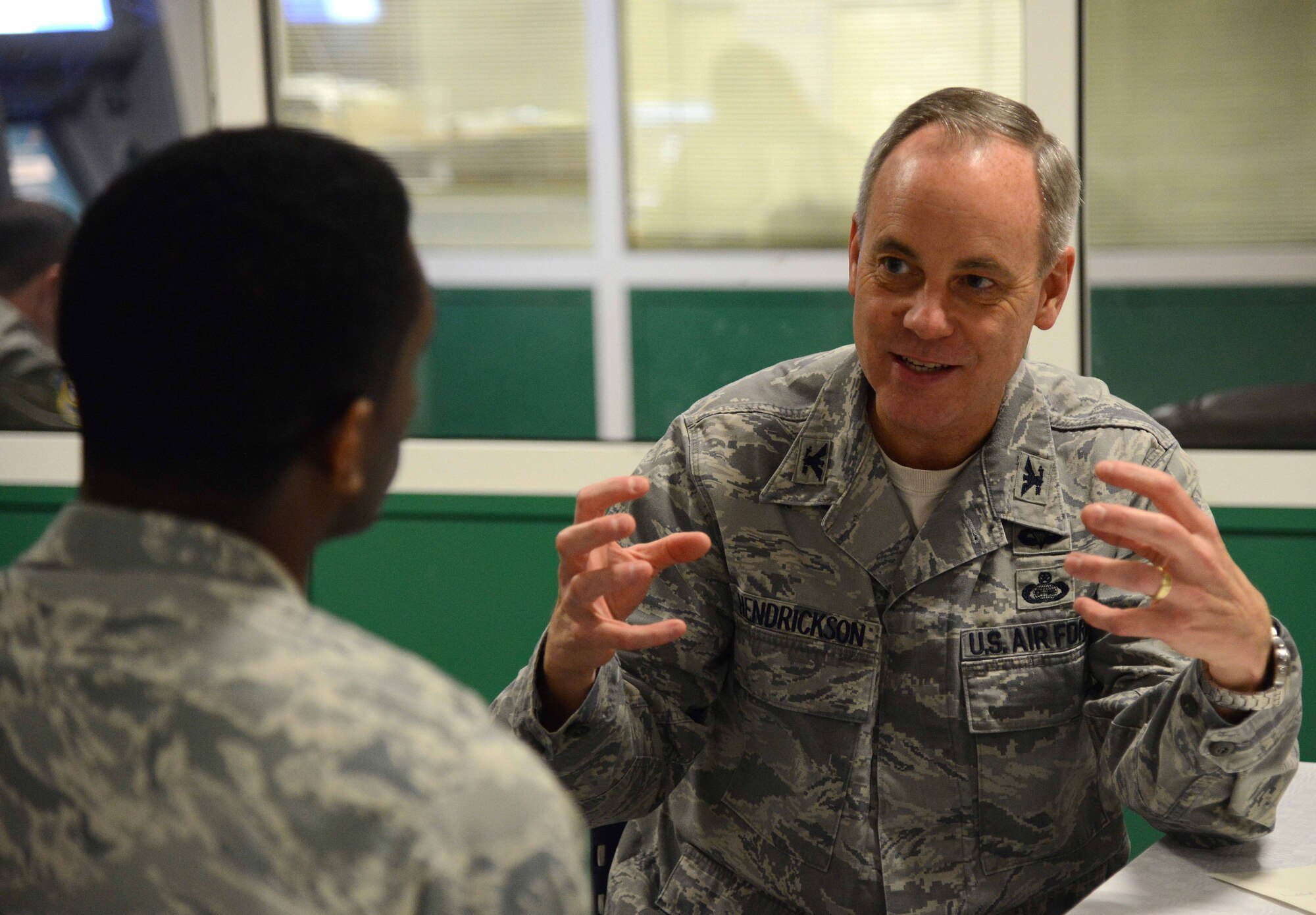 Col. Gordon Hendrickson, U.S. Air Forces in Europe Director of Intelligence, speaks with Capt. Ty Axson, USAFE Chief of Current Intelligence, Surveillance and Reconnaissance Operations-Europe, during a Senior Leader-To-Company Grade Officer Speed Mentoring event at Ramstein Air Base, Germany, Dec. 16, 2014. Senior leaders from around the Kaiserslautern Military Community mentored CGOs on various subjects including career progression and networking. (U.S. Air Force photo/Senior Airman Timothy Moore)