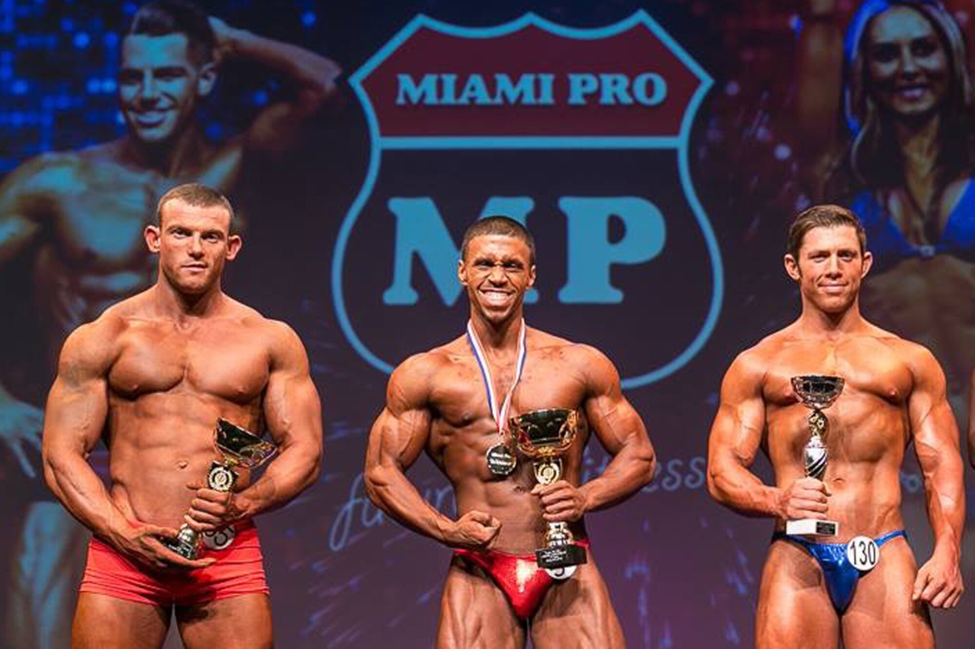Senior Airman Jeremey Pellot, 86th Airlift Wing general law paralegal, poses for a photo after winning first place in a Miami Pro bodybuilding competition Nov. 23, 2014, Herts, UK. With his first-place win, Pellot received professional status in the Miami Pro organization. (courtesy photo by Matt Marsh/ Released). 