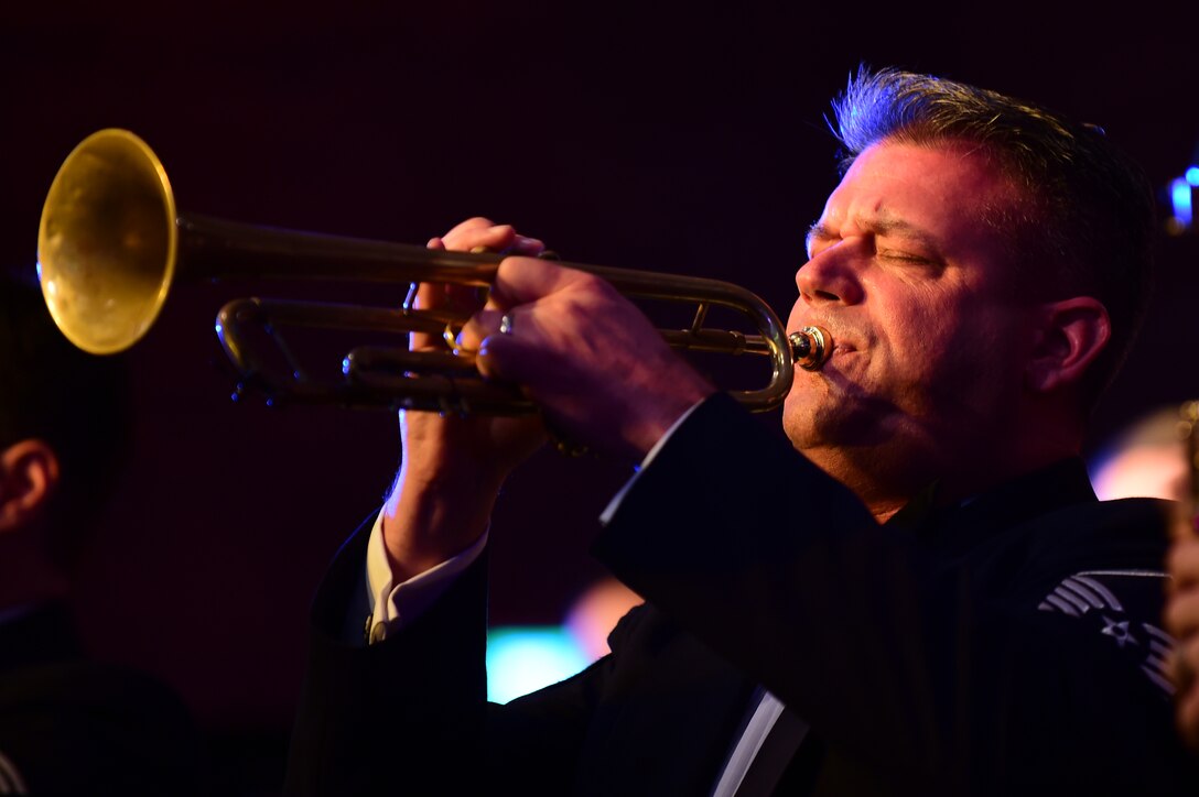 Master Sgt. Dave Dell plays a trumpet solo, during the U.S. Air Forces in Europe Concert band holiday celebration at Burgess Hall in St. Ives, Cambridgeshire, England, Dec. 18, 2014.  The band played songs ranging from “O Holy Night” to “Jingle Bells” as a way to say thank you to the community members who support USAFE installations (U.S. Air Force photo by Tech. Sgt. Chrissy Best)