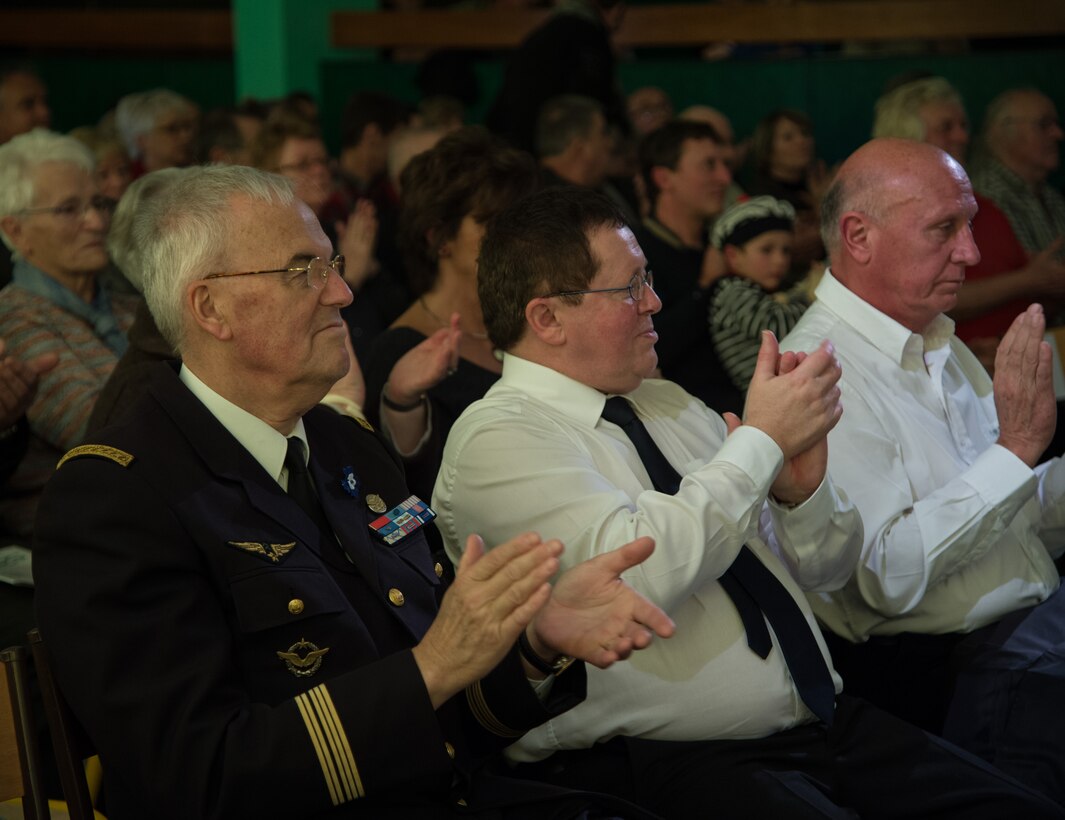 Ret. French Col. Pierre Antoine, left, watches the U.S. Air Forces in Europe Band perform during a Battle of the Bulge 70th anniversary commemoration event, Nov. 23, 2014, in Saulcy-sur Meurthe, France. The USAFE Band played throughout Europe since September stopping at villages that were affected by the battle. The band featured approximately 20 songs from the 1940s, bringing joy and nostalgia to the audience. (U.S. Air Force photo/Senior Airman Jonathan Stefanko)