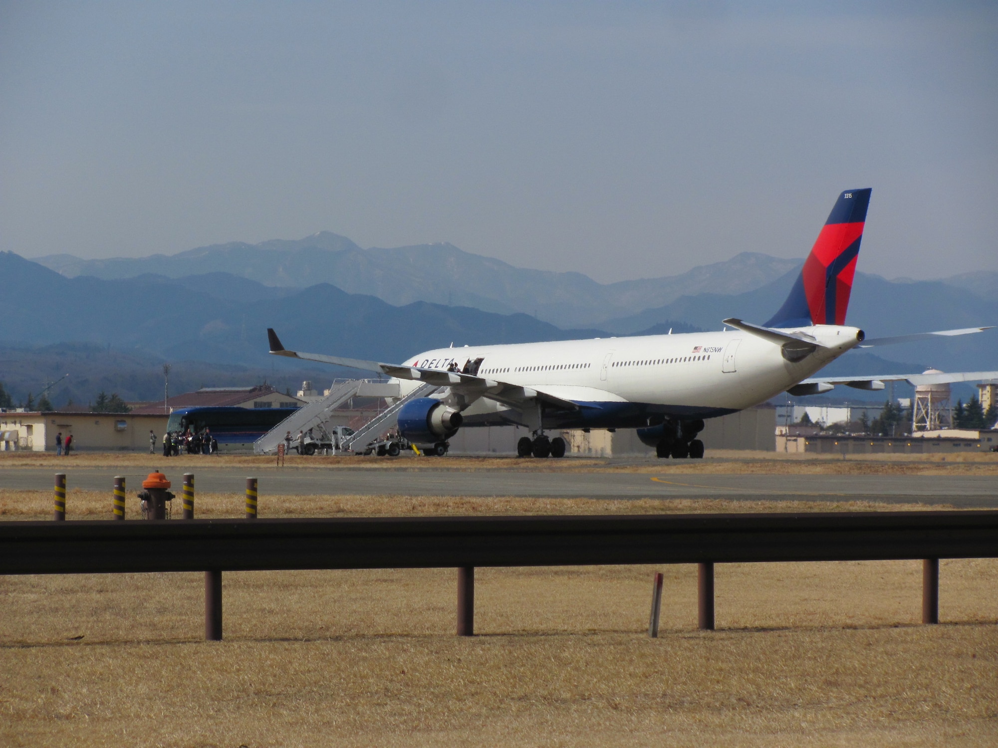 A 12 March 2011 photo of a diverted civilian airliner sitting on Yokota's
east ramp. The arrival of this and other airliners marked the beginning of
Operation Tomodachi for the 374th Airlift Wing. (Photo courtesy of the 374 AW History
Office.)
