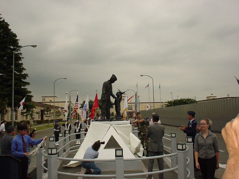 A 31 May 2001 photo of the dedication ceremony of Yokota's Tomodachi
statue that sits in the middle of Friendship Avenue. (Photo courtesy of the 374 AW History
Office.)

