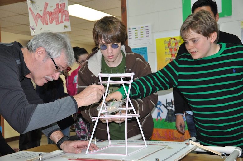 Doug Bliss (left), geotechnical and environmental engineering branch chief at the Far East District, helps Tristen Henley (center) and Jack Donoghe, eight grade students at Seoul American Middle School, during the earthquake tower challenge Jan. 9.

