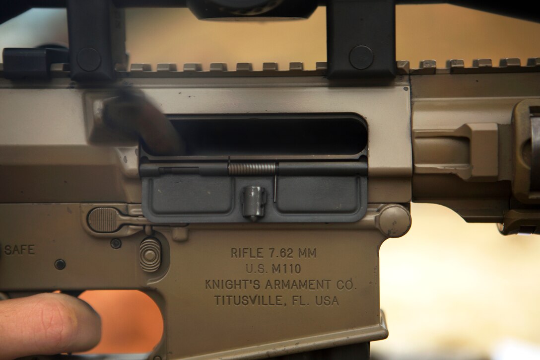 Casings of 7.62 mm ammunition are ejected from the chamber of an M110 semi-automatic sniper system during marksmanship and observer training on Camp Hansen, Okinawa, Japan, Jan. 6, 2015.