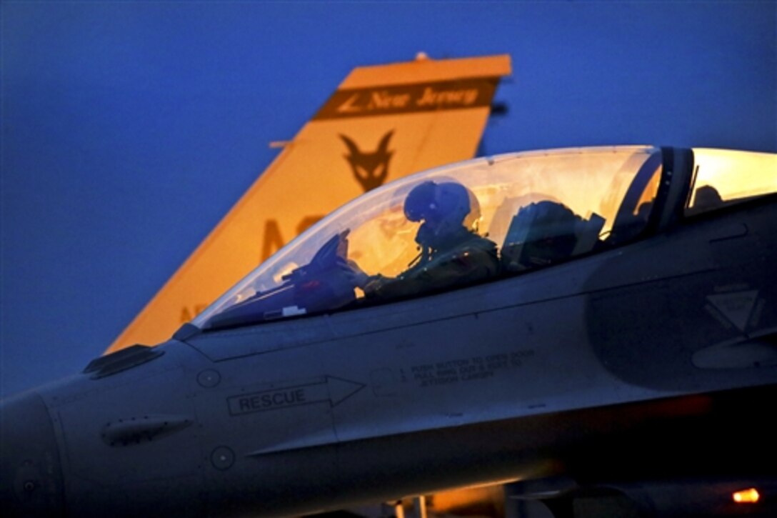 An Air Force F-16 Fighting Falcon pilot readies his aircraft for an early morning training exercise on the Atlantic City Air National Guard Base, N.J., Jan. 9, 2015. The pilot is assigned to the 177th Fighter Wing. The exercise tests the wing's capabilities to deploy on sorties or missions.New Jersey National Guard photo by Air Force Tech. Sgt. Matt Hecht