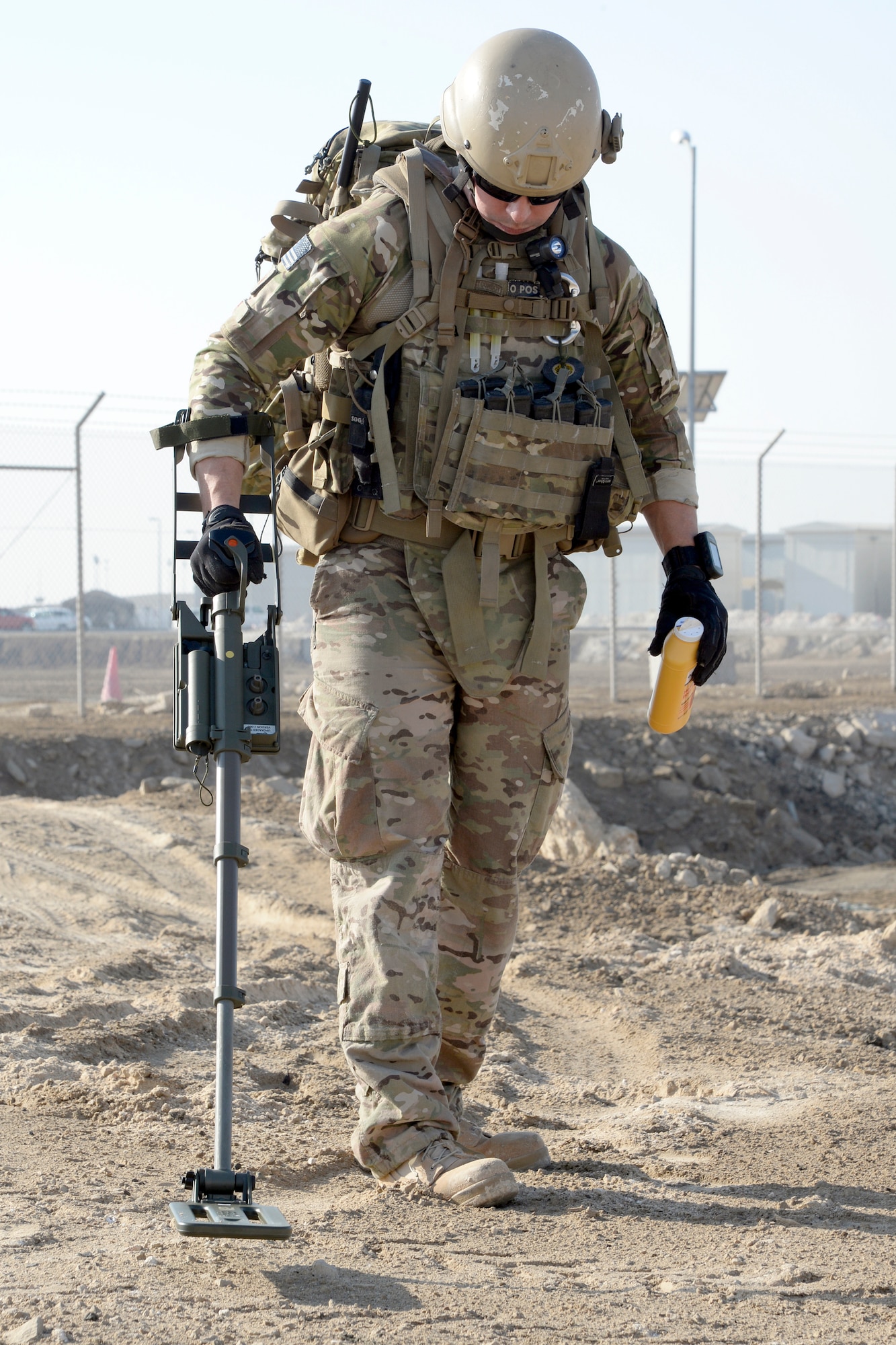 Staff Sgt. Ace, an explosive ordnance disposal technician, uses a metal detector to scan the area for a simulated improvised explosive device during a training exercise Dec. 30, 2014, in Southwest Asia. EOD Airmen are tasked with clearing munitions and enabling base operations to resume, such as clearing the airfield and creating an airstrip to get aircraft back in the air in order to provide defense. (U.S. Air Force photo/Tech. Sgt. Marie Brown)