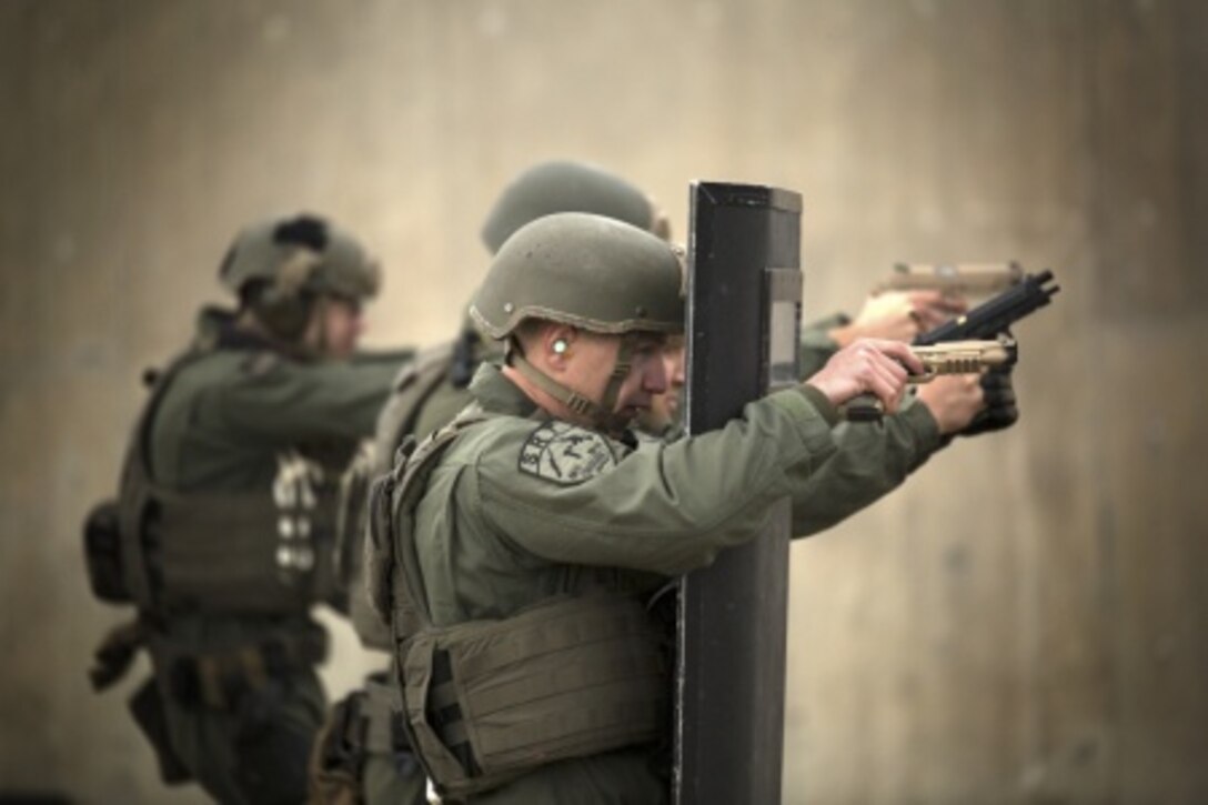 Lance Cpl. Christian Christopoulos engages targets behind a riot shield during weapons qualification Jan. 8 at Range 174 on Camp Hansen. Christopoulos is a Parker, Colo., native and a Special Reaction Team member with the Camp Foster Provost Marshal’s Office, Marine Corps Installations Pacific-Marine Corps Base Camp Butler. SRT is the military equivalent of Special Weapons and Tactics teams. 