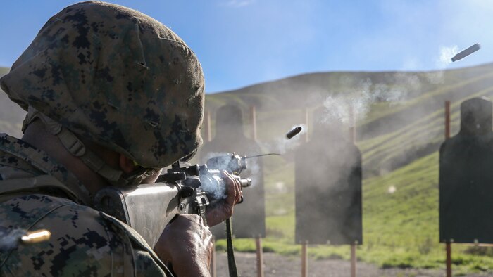 Gunnery Sgt. Michael Woods, electronic key management system manager with Marine Wing Communications Squadron (MWCS) 38, shoots an M16A4 rifle on Range 109 during Back in the Saddle training aboard Marine Corps Base Camp Pendleton, Calif., Jan. 7. Marines practiced marksmanship skills all while in full combat gear including Kevlar and flak jacket to make the training seem as real as possible.