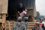 Guardsmen from the 1176th Transportation Company, Tennessee Army National Guard, stationaed in Smyrna, Tenn., help offload victims rescued from their homes due to severe flooding in Gallatin, Tenn. on May 2, 2010. Storms caused severe weather conditions throughout the South, forcing many residents to evacuate their homes.