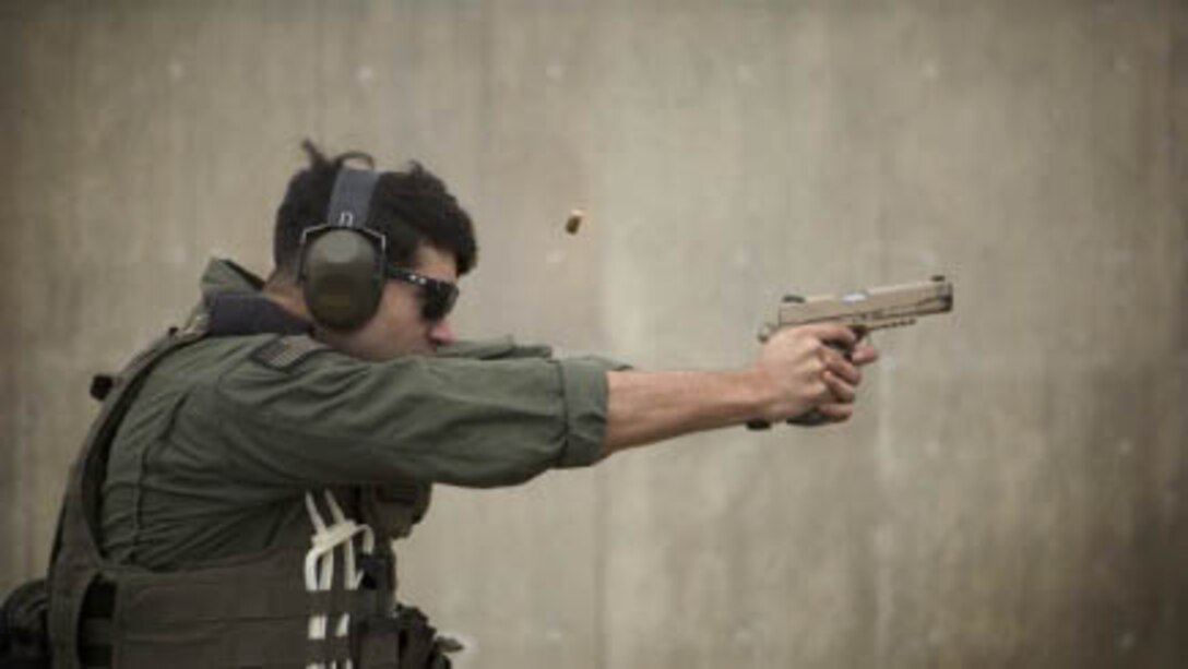 Cpl. Michael Fuentez fires an M45A1 close-quarters battle pistol at targets during weapons qualification Jan. 8 at Range 174 on Camp Hansen. Fuentez is with the Special Reaction Team, Camp Foster Provost Marshal’s Office, Marine Corps Installations Pacific-Marine Corps Base Camp Butler, Japan and a Los Angeles, Calif. native. The team is the military equivalent to Special Weapons and Tactics teams. 