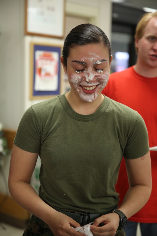 Lance Cpl. Neysa HuertasQuinones, a volunteer at the event, grins after completing a pie eating contest during the 8th annual commissary Special Olympics at Marine Corps Air Station Cherry Point, N.C. Jan. 12, 2015. HuertasQuinones is a combat correspondent with Headquarters and Headquarters Squadron and a native of Orlando, Fla.