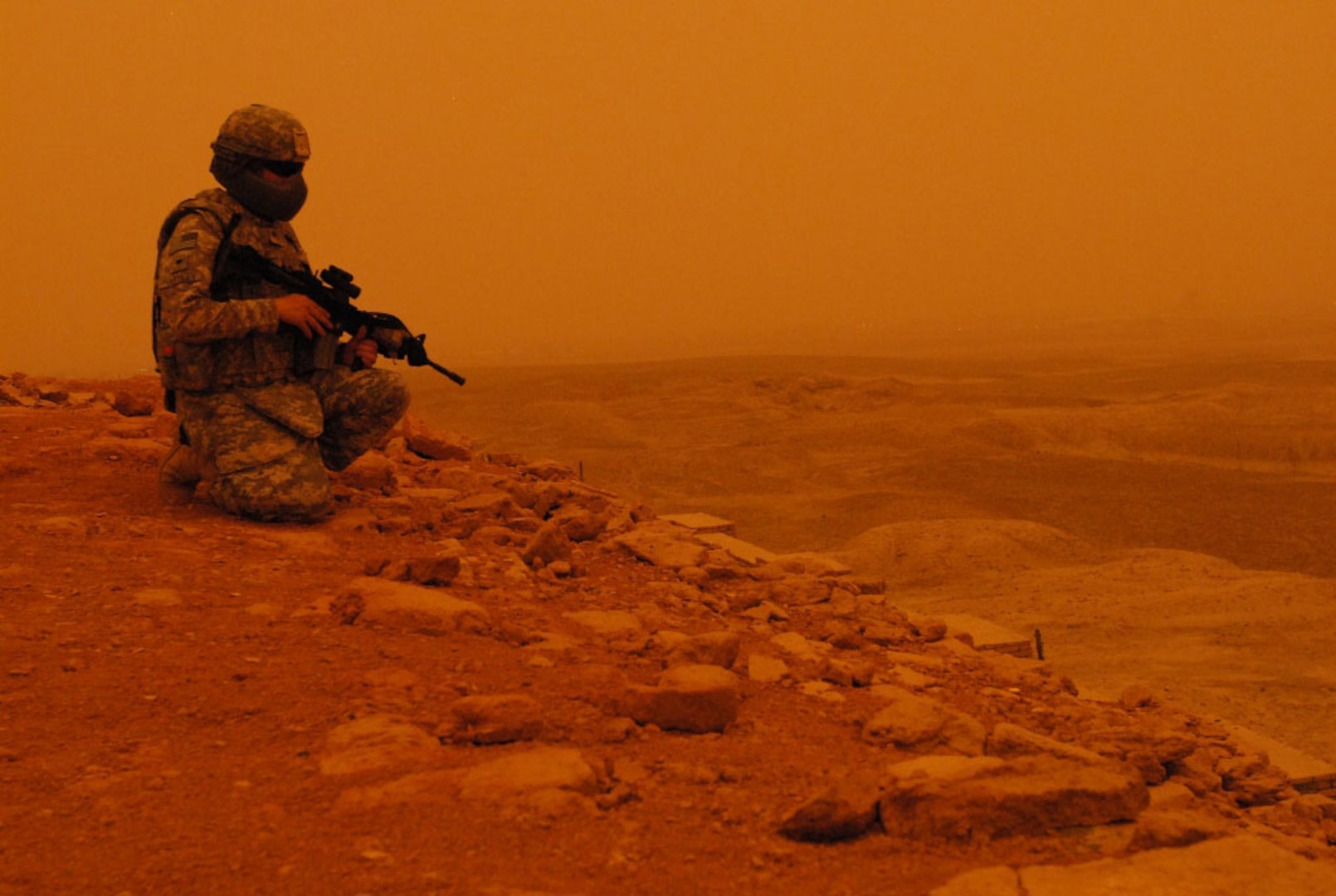 Dusty skies set in as a lone Virginia National Guard Soldier from 1st Battalion, 116th Infantry Regiment, headquartered in Lynchburg, Va., looks down across a valley from the Ziggurat of Ur near the Tallil Airbase in Iraq. The 1/116th is currently deployed with the Louisiana National Guard's 256th Infantry Brigade Combat Team, 13th Sustainment Command (Expeditionary) in support of Operation Iraqi Freedom.