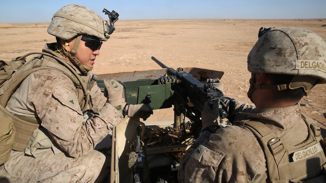 U.S. Marine Lance Cpl. Young Kim (left), a machine gunner with Golf Company, 2nd Battalion 7th Marine Regiment, Special Purpose Marine Air Ground Task Force-Crisis Response-Central Command, coaches Lance Cpl. Erik Delgadillo (right), an assault man, on the use of an M2 .50 caliber heavy machine gun, in the Central Command area of operations, Jan. 6, 2015. Marines and sailors of Golf Company spent time on the range getting acquainted with various weapons systems and cross-training one another in their respective areas of expertise. (U.S. Marine Corps photo by Cpl. Carson A. Gramley/Released)