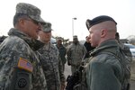 KUNSAN AIR BASE, Republic of Korea (Jan. 9, 2015) - Airman Michael Rowson, 8th Security Forces Squadron entry controller, briefs U.S. Army Gen. Curtis M. Scaparrotti, United Nations Command, Combined Forces Command, and U.S. Forces Korea commander, on security protocols during his first visit.  Gen. Scaparrotti had an opportunity to see firsthand how Kunsan Airmen contribute to deterring aggression on the Korean Peninsula.  140109-F-NB144-159  