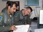 Pakistan Air Force Squadron Leader Azman Khalil, left, goes over flight
information with Capt. Andy Wittke, an instructor pilot with the Arizona Air
National Guard's 162nd Fighter Wing, before a training mission April 27, 2010. Khalil and seven other Pakistani pilots graduated from F-16C/D upgrade training at Tucson International Airport on May 4, 2010.