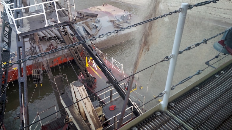 Crew members from the Dredge Potter use airlift dredging process to remove mud from the top of the suction ladder during repairs to the ladder rigging, Nov. 19, 2014. While working on the Kaskaskia River, the Dredge Potter experienced a D-ring failure (a critical link in the suction ladder lifting chains).