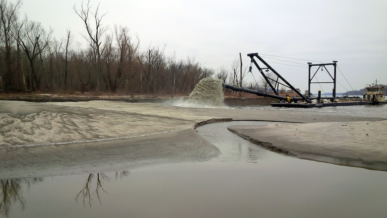 Dredge Potter pumping material into the scour hole below the Lock 25 spillway in Winfield, Missouri, Dec. 2, 2014. After engineers discovered erosion along the overflow dike at Lock and Dam 25 the Dredge Potter was brought in to assist in repairs before flooding could threaten the stability of the dike.