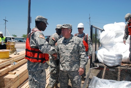 Maj. Gen. Bennett C. Landreneau, adjutant general of the Louisiana National Guard, thanks members of the 1022nd Engineer Company, 527th Engineer Battalion, at the Breton Sound Marina for their help during operations related to the oil spill off the coast of Louisiana, May 4, 2010. The 1022nd is assisting St. Bernard Parish officials and Oil Mop, LLC, with oil booms support.