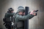 CAMP HANSEN, OKINAWA, Japan (Jan. 8, 2015) - Lance Cpl. Christian Christopoulos engages targets behind a riot shield during weapons qualification at Range. Christopoulos is a Parker, Colo., native and a Special Reaction Team member with the Camp Foster Provost Marshal's Office, Marine Corps Installations Pacific-Marine Corps Base Camp Butler. SRT is the military equivalent of Special Weapons and Tactics teams. 