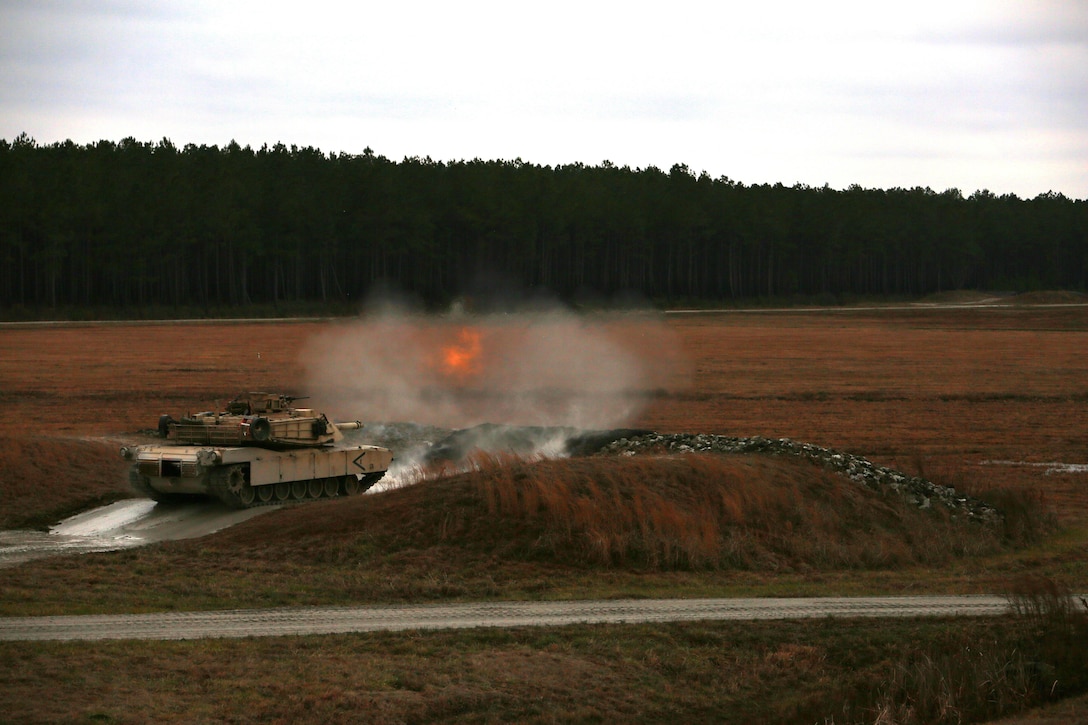 Marines with Tank Platoon, Company B, Ground Combat Element Integrated Task Force, fire the 120mm main gun of the M1A1 Abrams tank during a live-fire training exercise at Range SR-10, Marine Corps Base Camp Lejeune, North Carolina, Jan. 13, 2015. Marines with Tank Platoon conducted offensive and defensive engagements to prepare for an upcoming assessment at Marine Corps Air Ground Combat Center Twentynine Palms, California. From October 2014 to July 2015, the GCEITF will conduct individual and collective level skills training in designated ground combat arms occupational specialties in order to facilitate the standards based assessment of the physical performance of Marines in a simulated operating environment performing specific ground combat arms tasks. (U.S. Marine Corps photo by Sgt. Alicia R. Leaders/Released)
