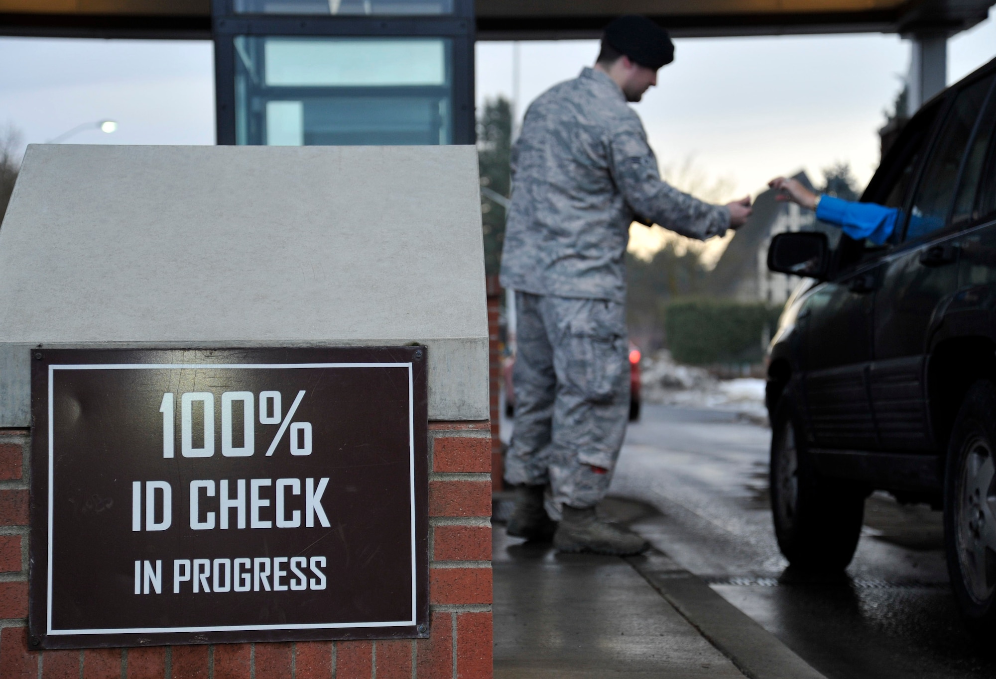 Airman 1st Class Brandon Feaser, 92nd Security Forces Squadron installation entry controller, scans identification cards, Jan. 6, 2015, at Fairchild Air Force Base, Wash. Fairchild requires 100 percent identification checks for all individuals coming on to the base to ensure only authorized individuals gain access. (U.S. Air Force photo/Airman 1st Class Nicolo J. Daniello)
